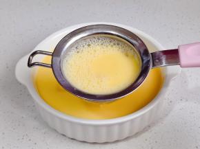 将蛋液过细筛到豆腐碗中。