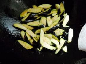 锅烧热加2茶匙油，下茄子略煎，盛起备用。