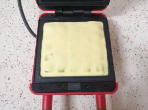 华夫饼机预热，上下盘分别刷上一层玉米油，倒入蛋糊。