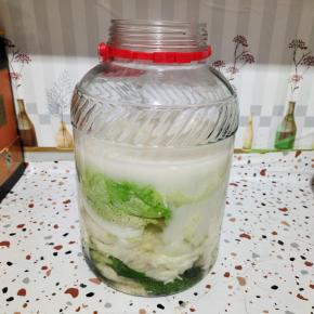 晾至温热，倒进玻璃瓶里！要多倒一点，面粉水要完全把白菜淹没住，不让白菜接触到空气，这样就不会腐烂变质！