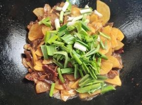 放入蒜苗翻炒均匀！