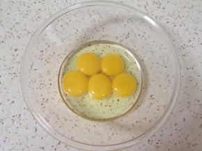 蛋清蛋黄分离，蛋黄里面加入玉米油用手动打蛋器搅打均匀。