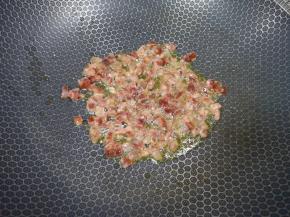 炒锅内倒少许菜籽油烧热，下入腊肠小火翻炒至透明状。