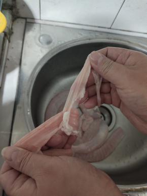 把清洗干净的猪小肠翻过来，把内壁多余的油脂撕下来！