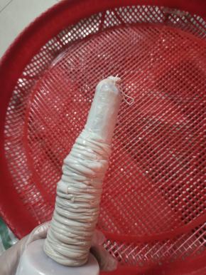 把猪肠衣挤干水分，套在灌肠器上!再在顶端打一个结!(或者用棉绳扎紧也可以!)