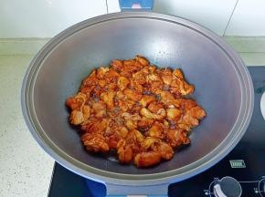 锅中油热放入鸡腿。