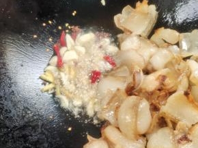 把多余的油倒出来，留少许油，放入生姜，花椒，蒜瓣，干辣椒爆香！