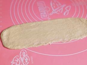 取一块面团擀长舌装卷起来。