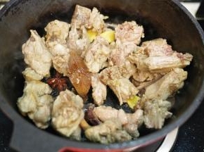 放入去血沫的鸭腿、香叶、桂皮、八角、料酒一起翻炒至鸭腿表面焦黄