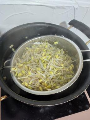 水烧开，把黄豆芽放进去焯水两分钟至黄豆芽熟了，没有豆腥味儿！捞出控干水分备用！
