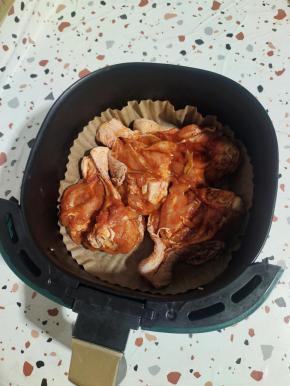 空气炸锅里放一个油纸碗，把腌制好的鸡腿放进去！