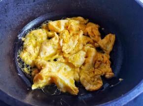 锅中热油，加入鸡蛋煎熟铲成小块盛出备用。