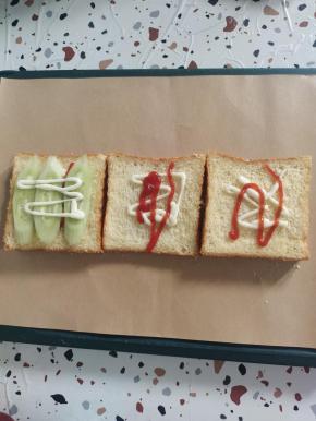 第一片吐司上放上黄瓜片，然后再挤适量的沙拉酱！(可以把黄瓜片换成嫩生菜，今天去超市没有买到生菜，就用黄瓜来代替了！)