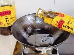 锅中倒入金龙鱼外婆乡小榨菜籽油。